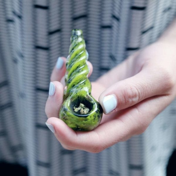 Blue Painted Nails Holding Loaded Pipe