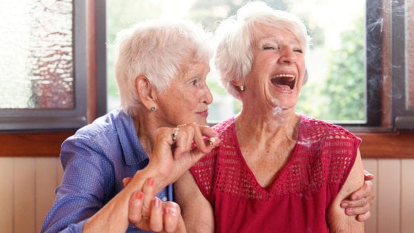Octogenarian friends smoking medicinal marijuana together.